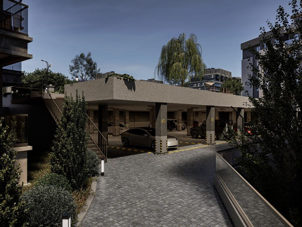 Akşam saatlerinde aydınlatılmış site girişi ve araç yolu